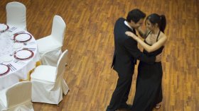 A couple dance in a ballroom